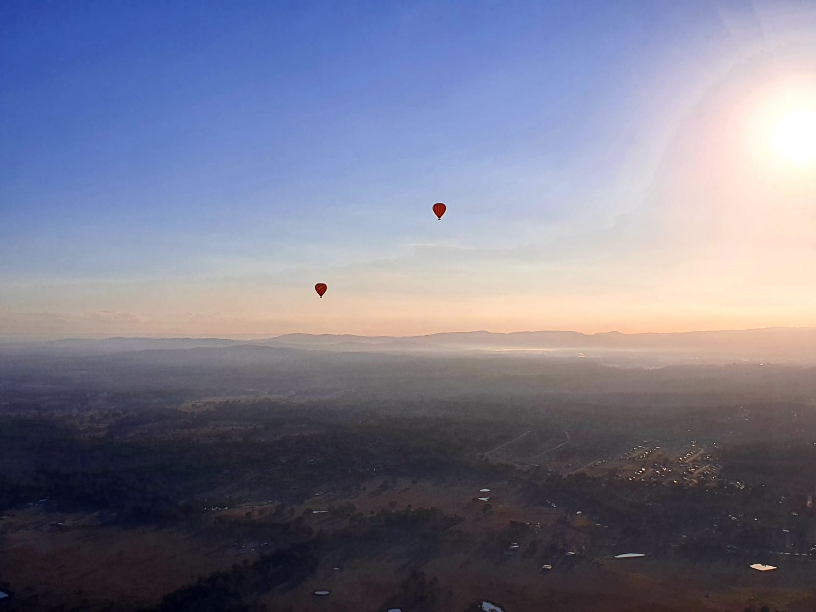 Morning light as two hot airballoons enjoy the view.